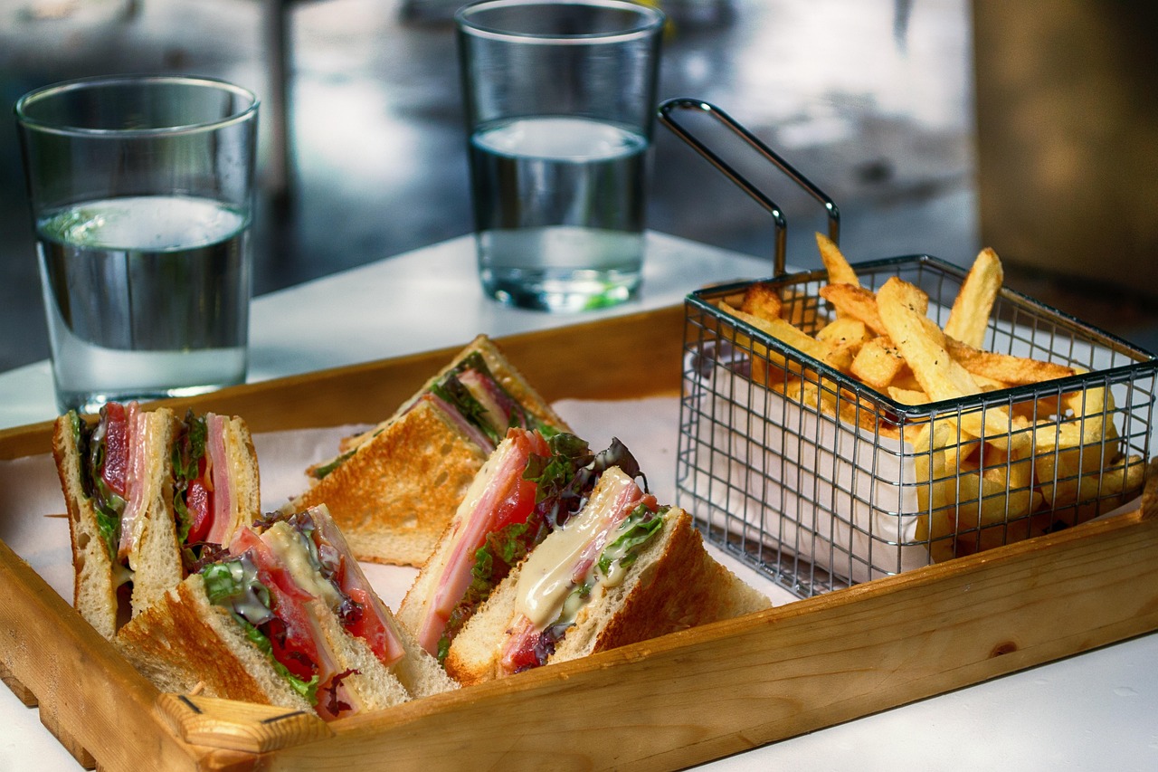 A toasted sandwich stacked high, served with crispy fries